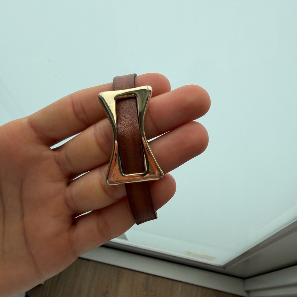 Leather bracelet with a gold-tone buckle